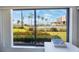 Window view from condo overlooking pool, palm trees, bay, and walking bridge at 6357 Bahia Del Mar Blvd # 111, St Petersburg, FL 33715