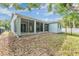 Spacious backyard featuring a screened patio and lush green grass at 7039 Woodibis Dr, New Port Richey, FL 34654