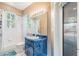 Traditional bathroom with blue vanity and bathtub/shower combination at 7039 Woodibis Dr, New Port Richey, FL 34654