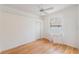 Bright bedroom with hardwood floors, ceiling fan and plantation shutters at 7039 Woodibis Dr, New Port Richey, FL 34654