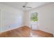 Bright bedroom with hardwood floors, ceiling fan and plantation shutters at 7039 Woodibis Dr, New Port Richey, FL 34654
