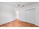 Bedroom with light walls and hardwood floors, features a ceiling fan and closet at 7039 Woodibis Dr, New Port Richey, FL 34654
