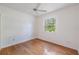 Sunlit bedroom with hardwood floors and a large window overlooking lush greenery at 7039 Woodibis Dr, New Port Richey, FL 34654
