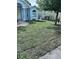Expansive front lawn featuring freshly laid sod, accentuating the home's curb appeal at 7039 Woodibis Dr, New Port Richey, FL 34654