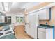 Bright eat-in kitchen featuring modern appliances, light countertops, and wood-style floors at 7039 Woodibis Dr, New Port Richey, FL 34654