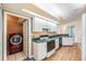 Cozy kitchen with a stainless-steel refrigerator, a laundry closet, and light countertops at 7039 Woodibis Dr, New Port Richey, FL 34654