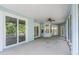 Relaxing lanai with tiled floors, ceiling fan and seamless transition to the outdoors through sliding glass doors at 7039 Woodibis Dr, New Port Richey, FL 34654