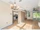 Open living area featuring wood-look floors, views of the kitchen, and sliding glass doors to the outside at 7039 Woodibis Dr, New Port Richey, FL 34654