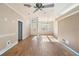 Open-concept living room showcasing wood floors, natural light, and views of the front entryway at 7039 Woodibis Dr, New Port Richey, FL 34654