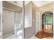 Modern main bathroom features a glass-enclosed shower and an adjoining walk-in closet at 7039 Woodibis Dr, New Port Richey, FL 34654