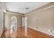 Spacious main bedroom with hardwood floors, ceiling fan, and arched entrance to the main bathroom at 7039 Woodibis Dr, New Port Richey, FL 34654