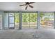 Spacious screened-in patio overlooking a private backyard with mature trees at 7039 Woodibis Dr, New Port Richey, FL 34654