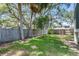 Spacious backyard with mature trees, lush green grass, and a privacy fence at 7113 S Kissimmee St, Tampa, FL 33616