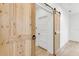 Unique barn door detail adds character to this room, complementing the wood-look flooring at 7113 S Kissimmee St, Tampa, FL 33616