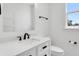 Bathroom featuring bright white walls, a white vanity, and black hardware at 7113 S Kissimmee St, Tampa, FL 33616