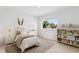 Charming bedroom with neutral carpet, a window, and a cute bookshelf for a cozy room at 7113 S Kissimmee St, Tampa, FL 33616