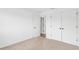 Bright empty bedroom with neutral carpet, a large closet, and a view of an open doorway at 7113 S Kissimmee St, Tampa, FL 33616