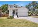 Charming two-story home with a manicured lawn, two car garage, and inviting front entrance at 7113 S Kissimmee St, Tampa, FL 33616
