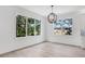 Living room bathed in natural light with large windows offering a scenic view of the outdoors at 7113 S Kissimmee St, Tampa, FL 33616