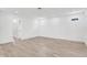Spacious living room featuring wood-look floors and ample natural light at 7113 S Kissimmee St, Tampa, FL 33616