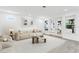 Bright, open living room with neutral decor, wood-look tile floors and plenty of natural light at 7113 S Kissimmee St, Tampa, FL 33616