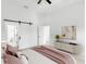 Main bedroom with barn door leading to bathroom and decorative furniture at 7113 S Kissimmee St, Tampa, FL 33616