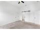 Main bedroom with sliding barn door and two closet doors at 7113 S Kissimmee St, Tampa, FL 33616
