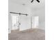 Main bedroom with barn door leading to bathroom with plenty of space at 7113 S Kissimmee St, Tampa, FL 33616