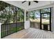 Screened porch features a ceiling fan and views of the lush greenery at 7113 S Kissimmee St, Tampa, FL 33616
