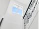 Staircase with white walls and black railings under a bright window at 7113 S Kissimmee St, Tampa, FL 33616