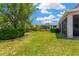 Large backyard with lush green lawn, screened patio and potential for outdoor activities at 7502 Sea Lilly Ct, Apollo Beach, FL 33572