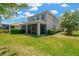 Spacious backyard with lush green grass, a screened-in porch, and well-maintained landscaping at 7502 Sea Lilly Ct, Apollo Beach, FL 33572