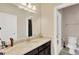 Bathroom featuring granite counters, black cabinets and a doorway to the water closet at 7502 Sea Lilly Ct, Apollo Beach, FL 33572