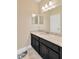 Bathroom with black cabinets, granite countertop, and a large mirror at 7502 Sea Lilly Ct, Apollo Beach, FL 33572