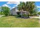 Well-maintained home with a manicured lawn and beautiful landscaping, including palm trees at 7502 Sea Lilly Ct, Apollo Beach, FL 33572
