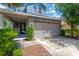 Charming home featuring a two-car garage, stone accents and well-manicured landscaping at 7502 Sea Lilly Ct, Apollo Beach, FL 33572