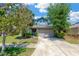 Inviting two-story home featuring a manicured lawn, mature trees, and a two-car garage at 7502 Sea Lilly Ct, Apollo Beach, FL 33572