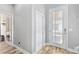 Bright hallway featuring tiled floors, modern doors, and ample natural light at 7502 Sea Lilly Ct, Apollo Beach, FL 33572