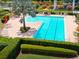 Aerial view of an outdoor pool featuring an olympic size lap pool, lounge chairs, and palm trees at 7502 Sea Lilly Ct, Apollo Beach, FL 33572