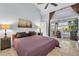 Bedroom with a backyard view, ceiling fan, and decoratively painted wall at 865 Live Oak Ne Ter, St Petersburg, FL 33703