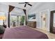 Bedroom with sliding glass door to backyard, ceiling fan, and decorative paintings at 865 Live Oak Ne Ter, St Petersburg, FL 33703