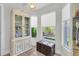 Cozy breakfast nook featuring travertine floors, a classic hutch, and natural light from the windows at 865 Live Oak Ne Ter, St Petersburg, FL 33703