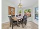 Bright dining room with modern table, travertine tile floors, and views of the private backyard at 865 Live Oak Ne Ter, St Petersburg, FL 33703