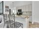 Kitchen bar with tile backsplash, stainless appliances and pendant lighting at 865 Live Oak Ne Ter, St Petersburg, FL 33703
