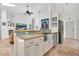 Open kitchen with an island featuring stainless steel appliances and travertine floors at 865 Live Oak Ne Ter, St Petersburg, FL 33703