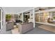 Relaxing screened patio with seating area, ceiling fans, and access to the outdoors, perfect for entertaining at 865 Live Oak Ne Ter, St Petersburg, FL 33703