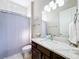 Bathroom featuring granite countertops, modern fixtures, vanity, and shower with tiled walls at 949 Symphony Isles Blvd, Apollo Beach, FL 33572