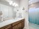 Bathroom featuring granite countertops, modern fixtures, vanity, and shower with tiled walls at 949 Symphony Isles Blvd, Apollo Beach, FL 33572