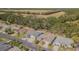 An aerial view of a residential neighborhood with mature trees and green space in the background at 9823 Rolling Cir, San Antonio, FL 33576