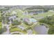 Aerial view of Tampa Bay Golf & Country Club, featuring a pool, lakes, golf course and many homes at 9823 Rolling Cir, San Antonio, FL 33576